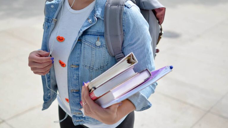 Student with backpack and books.
