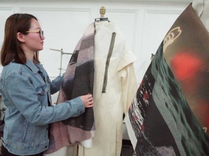 Student looking through sample fabrics