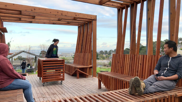 2 men sitting on sustainably built benches