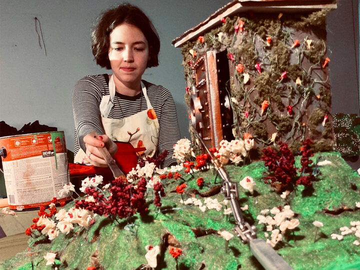 Young woman hand painting a set for use in stop motion film