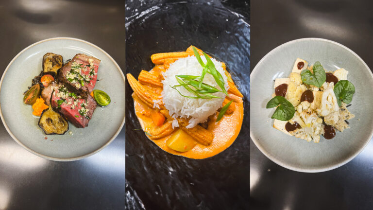 Three dishes on small plates: the first is seared meat with roasted eggplant and cherry tomatoes, garnished with herbs; the second is a mound of white rice served over a vegetable and sauce mixture with green onion garnish; the third is a cauliflower and cheese dish with basil leaves and dark sauce dots.