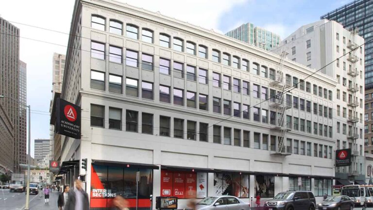 Building with multiple stories and large windows features a sign reading 